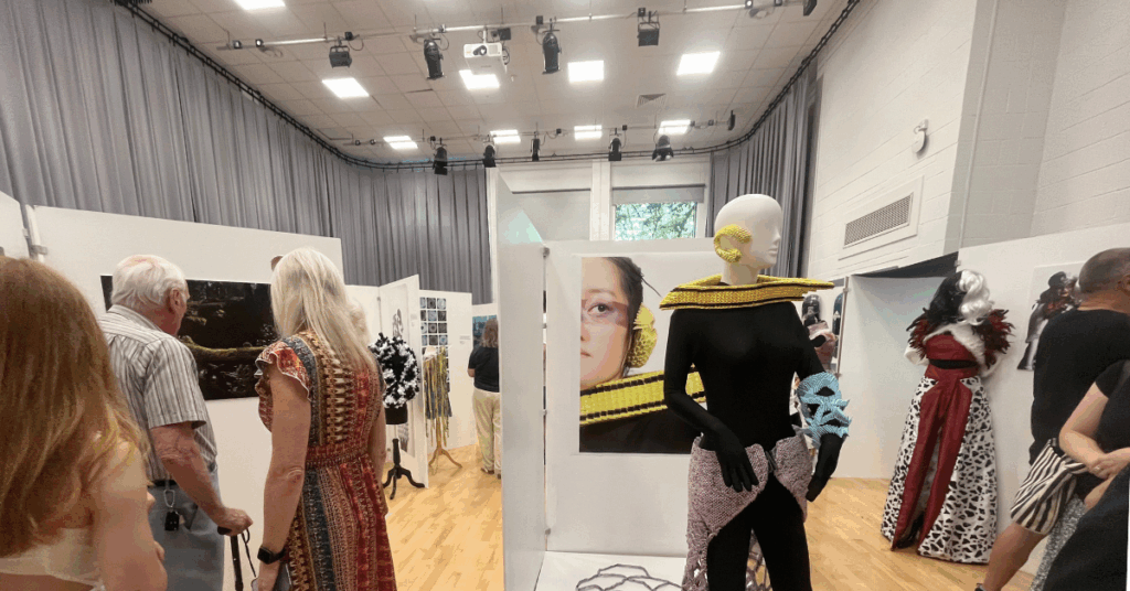 A picture of some visitors having a look at some of our student work exhibition.