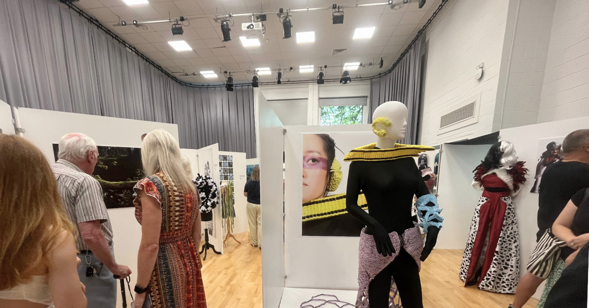 A picture of some visitors having a look at some of our student work exhibition.