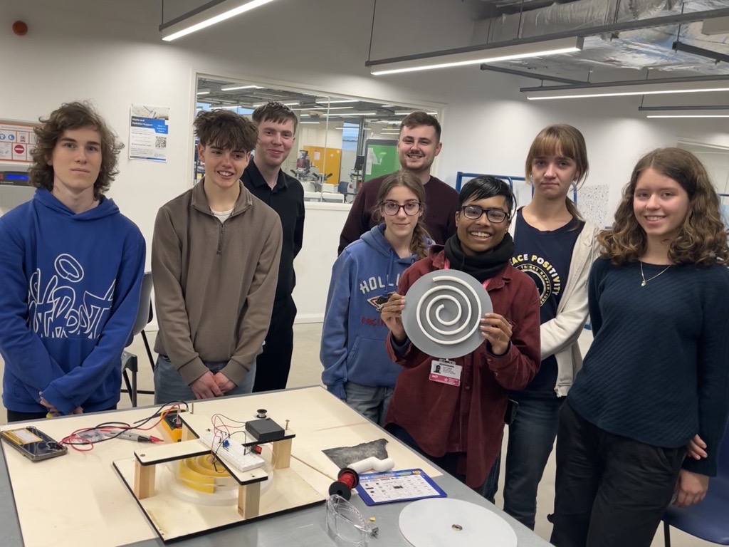 The industrial cadets Gold Project team from Haywards Heath College with engineering mentors Sam Ellis and James Vinson at Canterbury Christchurch University